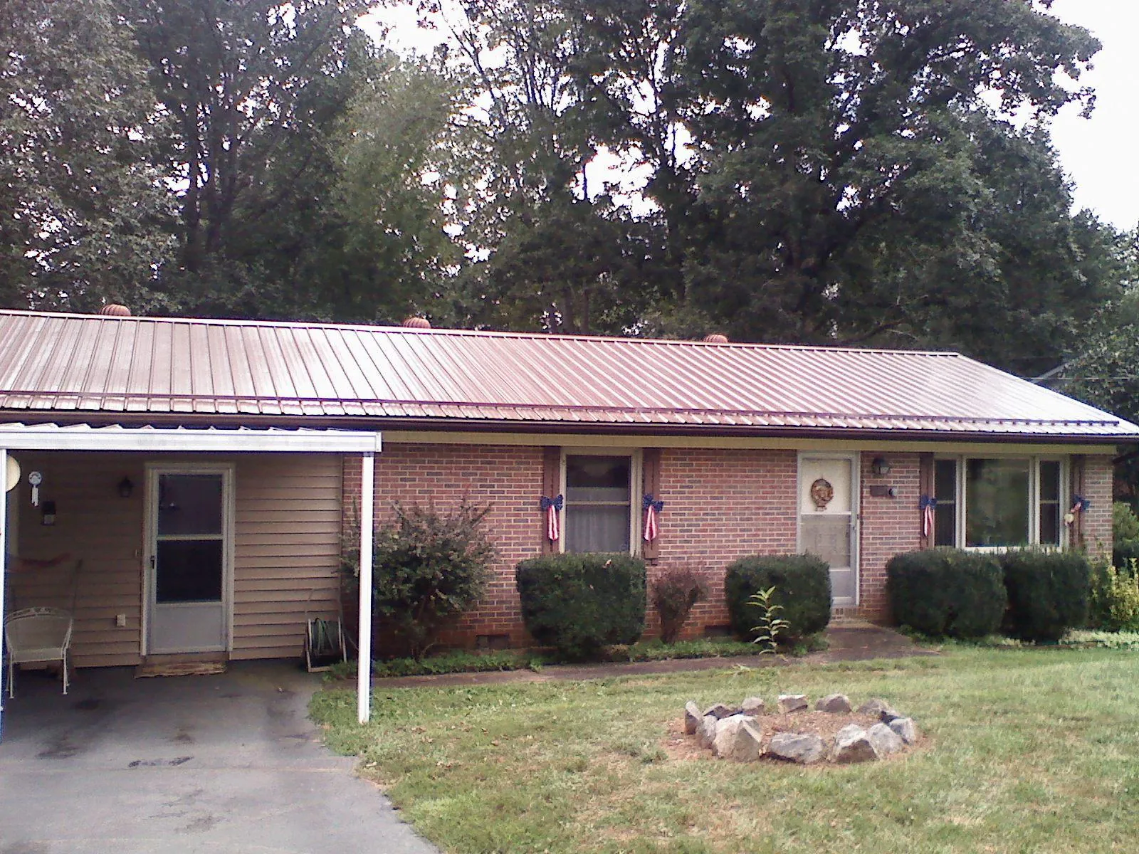 Bronze metal roof and carport on a brick ranch home — Roof Repair work by our crew in Montesano